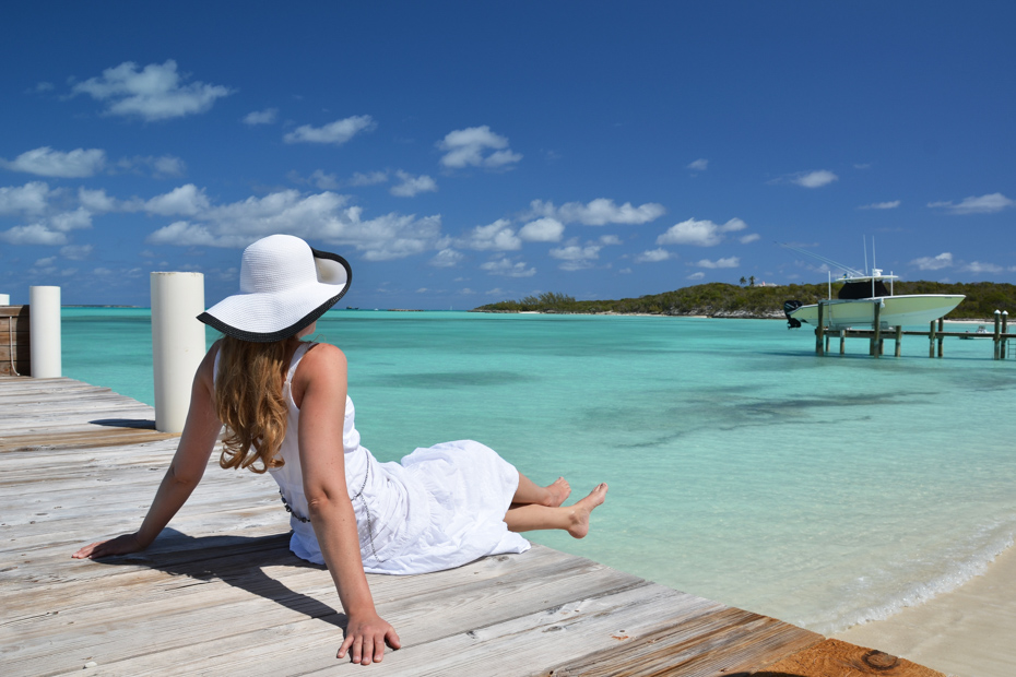 Girl on the wooden jetty looking to the ocean at Staniel Cay Exuma, Bahamas. Join the Staniel Cay Tours on any of the many Staniel Cay Day Trips from Florida