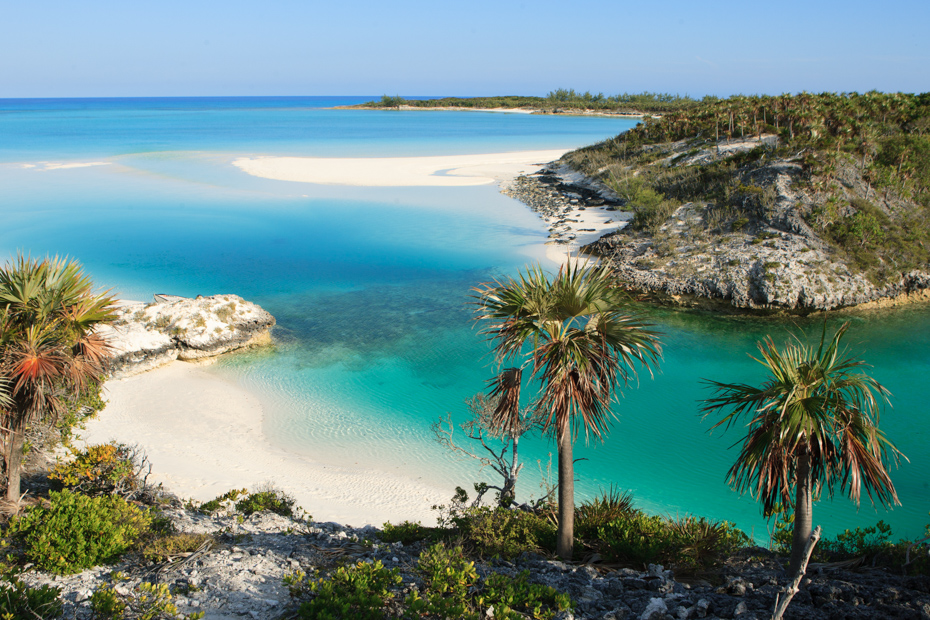 Aerial shot above a bay in the Exuma Cays. A Pig Beach excursion from Nassau to Exuma is a 30 minute flight on a Bahamas day trip.